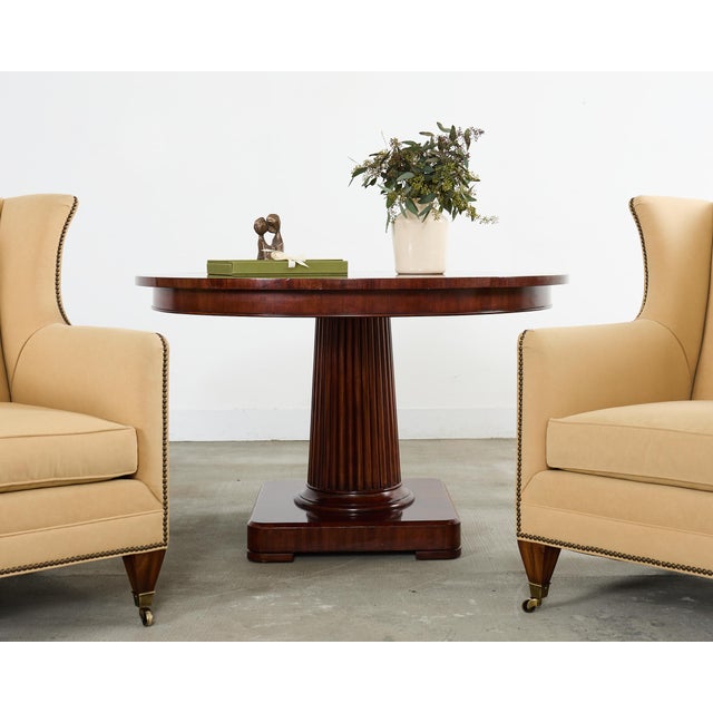 A refined "Mayfield Center Table" by Ralph Lauren features a substantial circular top finished in a radiant book matched...