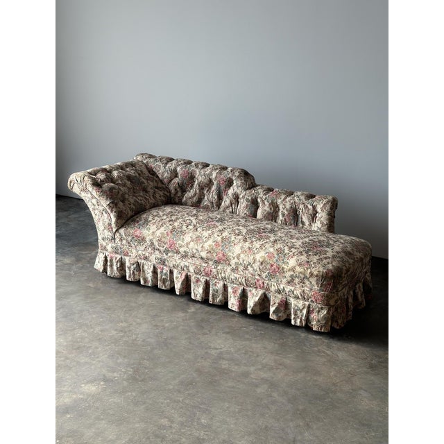 This 19th century Napoleon III antique chaise longue is defined by its sculptural silhouette — a scrolled, deeply button-...