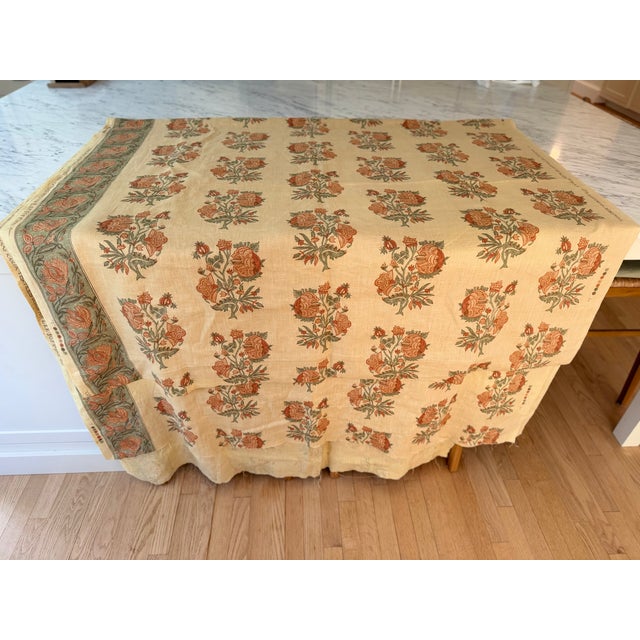 Lee Jofa "Concorde" is a large scale, linen, block print floral in orange, green, and brown tones on a wheat-colored...