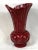 Vintage Mid-Century vase in deep oxblood red. The vase is decorated with shell like swirls that rise to wrapped ribbed...