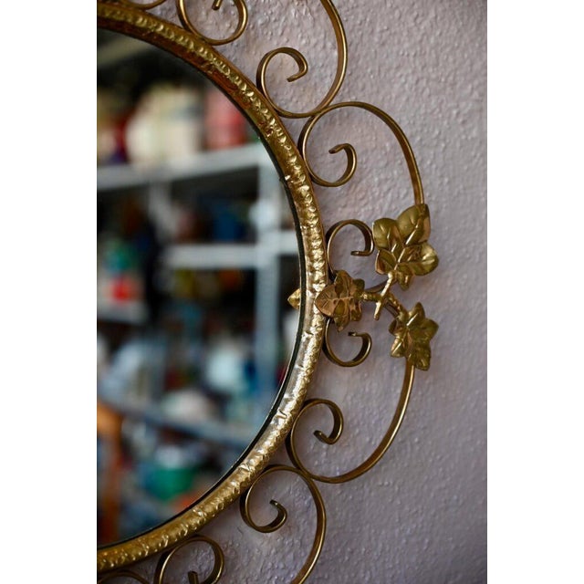 This pretty vintage mirror is as decorative as it is whimsical. We love its gold metal frame, decorated with scrolls and...