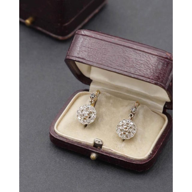 Edwardian cluster diamond earrings in 18 karat gold and platinum. Antique earrings featuring a movable daisy at the...