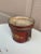 A wonderfully charming early 20th century French tole cachepot finished in a rich cinnabar red with delicate gilt...