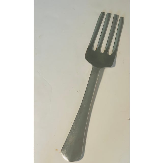 ,large display wall decor restaurant advertisement polished metal fork.