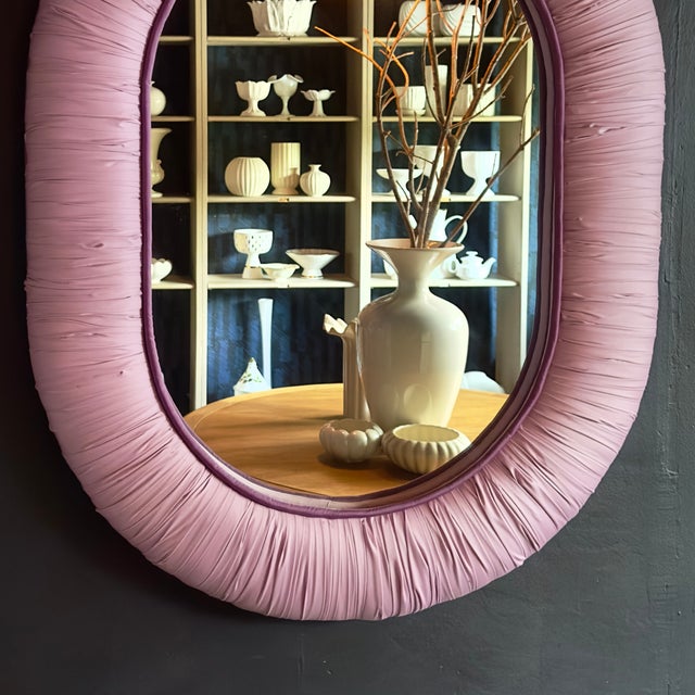 This stunning and distinct upholstered mirror combines tactile texture with a soft pastel palette to serve as a...