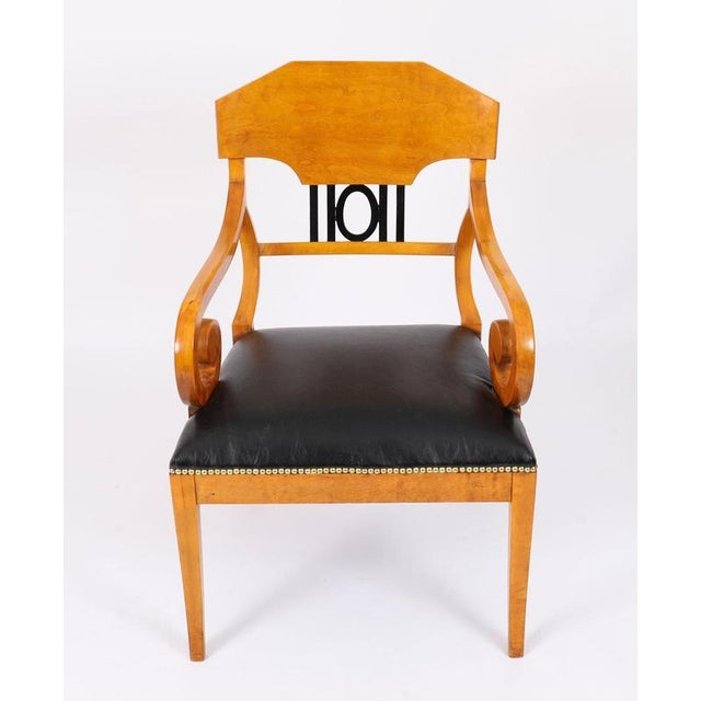 This is an elegant antique pair of Swedish Biedermeier figured birchwood open armchairs, circa 1880 in date. The chairs...