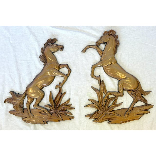 Great pair of Syroco decorative wall hanging 'Rodeo Horses' from the mid 20th century. Each is made of wood with a shiny...