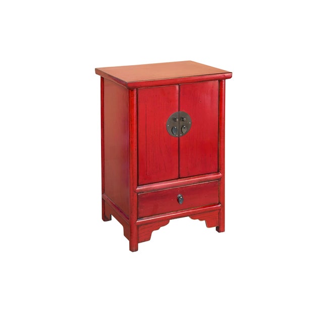 This striking Chinese-style accent cabinet features a vibrant distressed red lacquer finish, adding a bold pop of color...