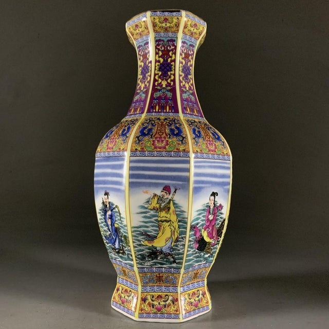 This stunning vase features a classic hexagonal (six-sided) form, with a flared rim and a tapering body. It showcases the...