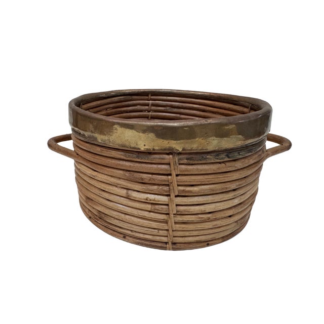Midcentury pencil reed basket with wide brass trim and handle detail. Styled in the manor of Gabriella Crespi.