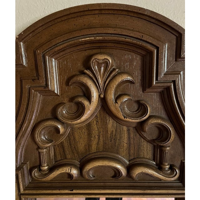 A striking matched pair of tall arched wall mirrors in the Spanish/Baroque Revival style, American-made, circa...