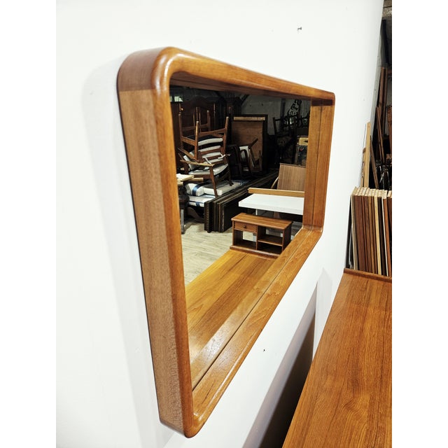 An exceptional, collectible wall mirror from the 1960s, epitomizing scandinavian mid-century modern design. Designed by...