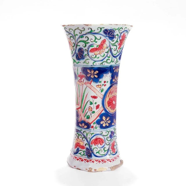 A fine Dutch Delft pottery beaker form vase. By Pieter Adriaensz Kocx of De Grieksche A. With a white ground and decorated...