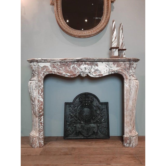 Antique french trois coquilles fireplace in pink and white color tones. This mantel (fireplace) piece gets its lovely...
