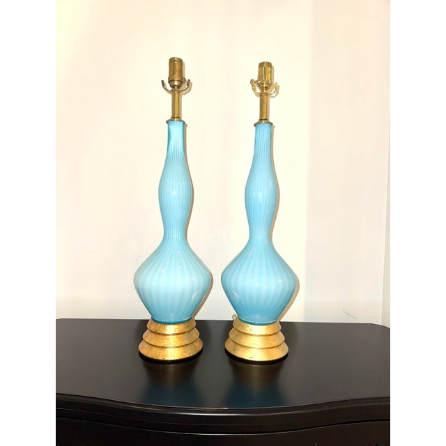 RARE vintage Murano blown glass lamps in a beautiful topaz blue. The glass has a ribbed effect that is simply beautiful in...