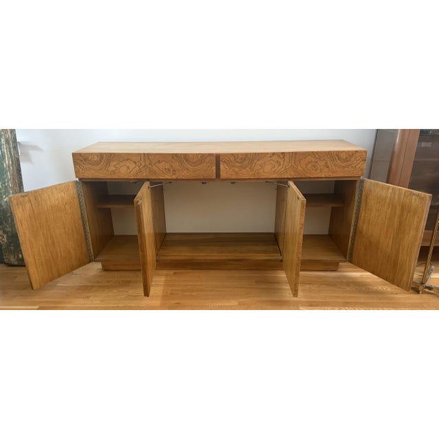 Add timeless warmth and sculptural flair to your living space with this noteworthy Art Deco-inspired burled ash credenza!...