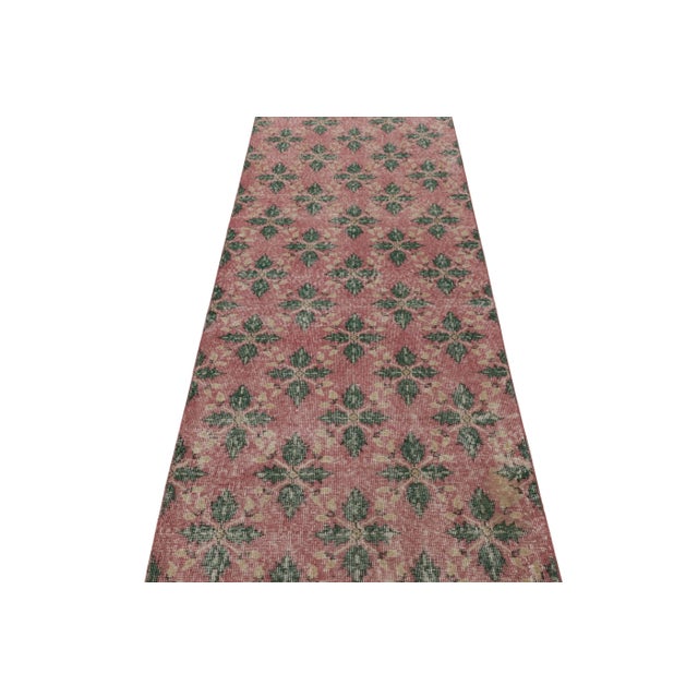 This vintage runner rug is a 3x10 Turkish distressed piece, made with hand-knotted wool circa mid-20th century. It is an...