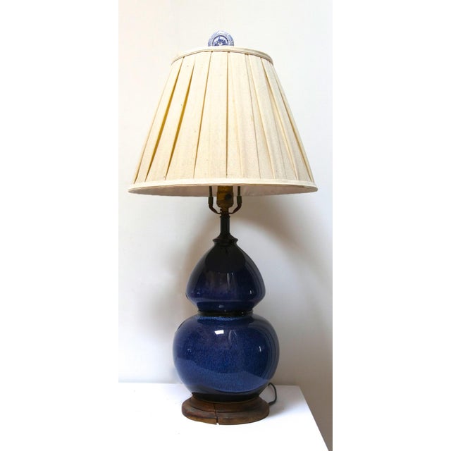 This double gourd lamp is fabulous in navy blue with an updated finial. This is a mid century modern lamp from a Redondo...