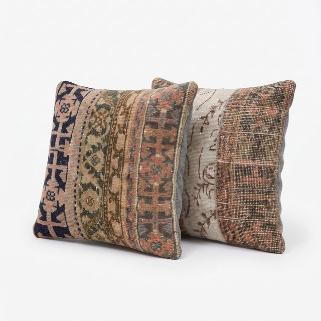 This 24'' x 24'' pillow cover set was made from authentic Turkish rug pieces — navy and olive geometric bands with rust...
