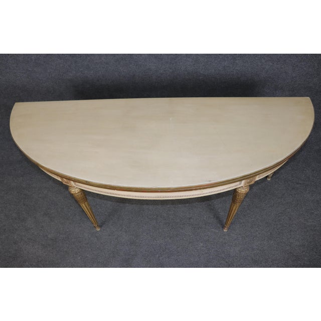 Elevate your interior with this elegant Maison Jansen paint-decorated console table, a refined example of French...