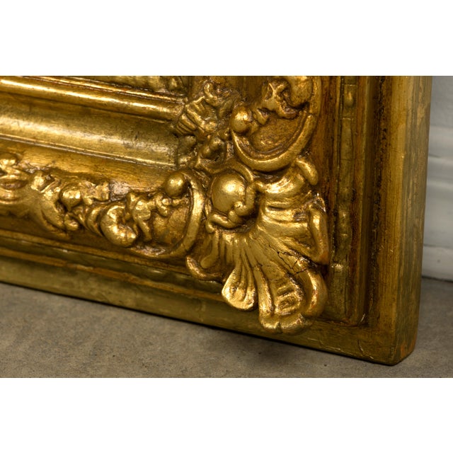 Sourced in Provence, France, this exceptional mid-19th-century French Louis Philippe giltwood mirror embodies both the...