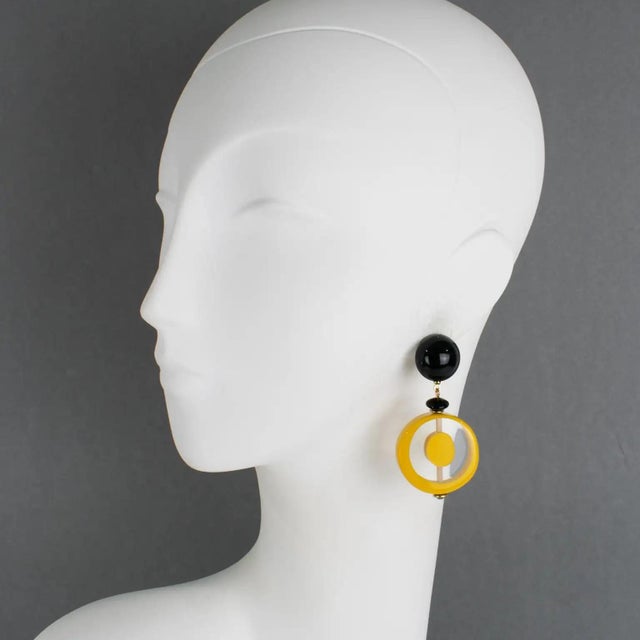 These stunning Angela Caputi pierced earrings, made in Italy, feature a 1970s revival-inspired design with geometric resin...