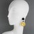 These stunning Angela Caputi pierced earrings, made in Italy, feature a 1970s revival-inspired design with geometric resin...