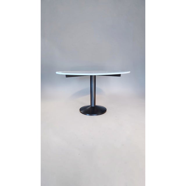 The design for this table began in the late 1940s and was completed in 1961. The base is a single cast metal piece painted...