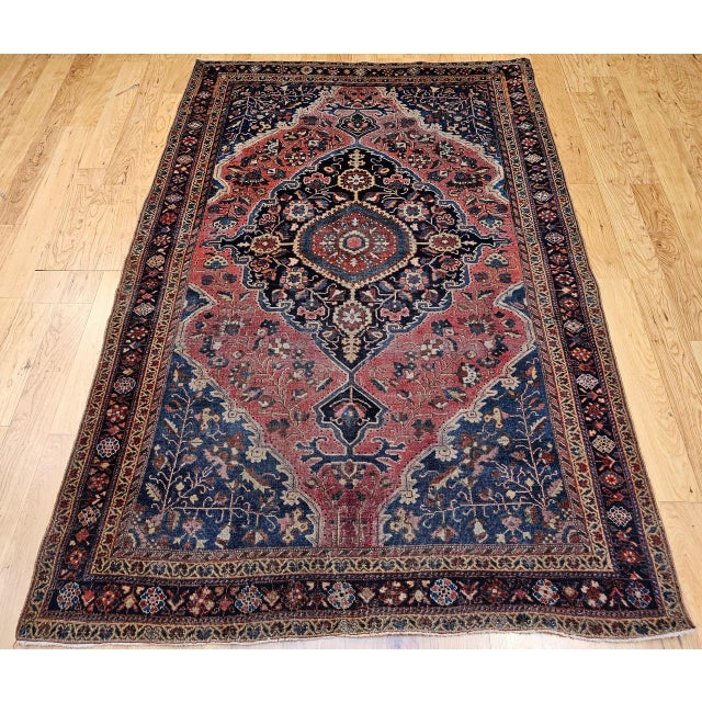 "An early 20th century Persian Farahan Sarouk area rug in a classic medallion pattern of refined elegance. Hand-knotted...