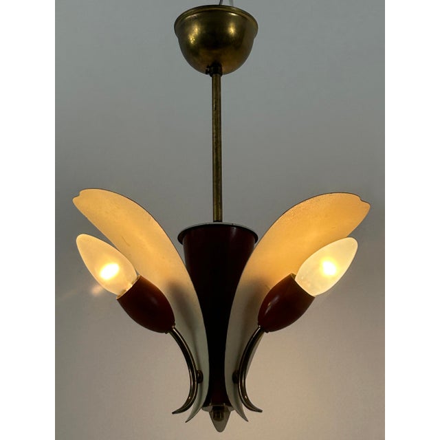 Extremely rare, elegant and highly decorative mid-century modern ceiling lamp or pendant light with three metal reflector...