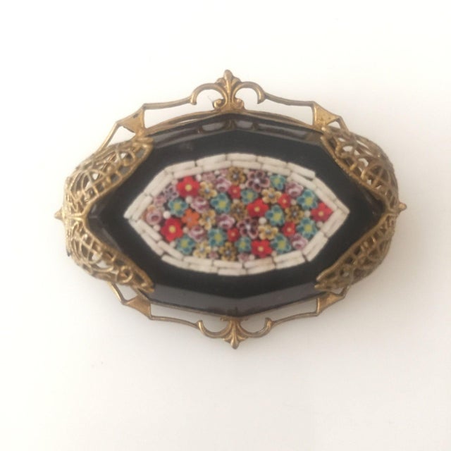 Late Victorian Murano glass mosaic on a black jet stone set in a golden filigree backing. Measures: 1 3/4" long x 1 1/4"...