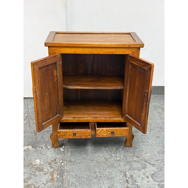 Design Plus Gallery presents a 19th Century Chinese Elmwood Wedding Cabinet. This antique elmwood cabinet has a honey...