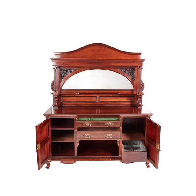 This is a large quality antique carved mahogany sideboard by Maple & Co. It boasts an attractive arched mirrored back with...