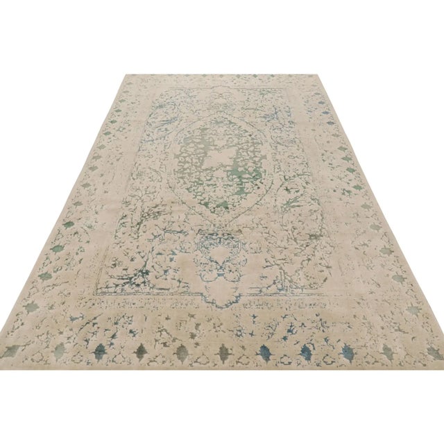 Hand-knotted in wool, this 6x10 modern rug by Rug & Kilim enjoys an abstract design with a subtle inspiration from antique...