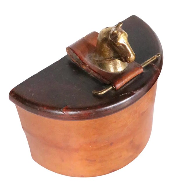 Chic pair of leather wrapped Art Deco bookends, having a cast metal horse head with metal riding crop on top. The bookends...