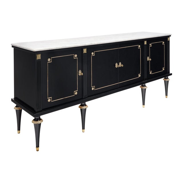 An elegant French Louis XVI style four-door buffet or enfilade; circa 1910; crafted primarily of mahogany; professionally...