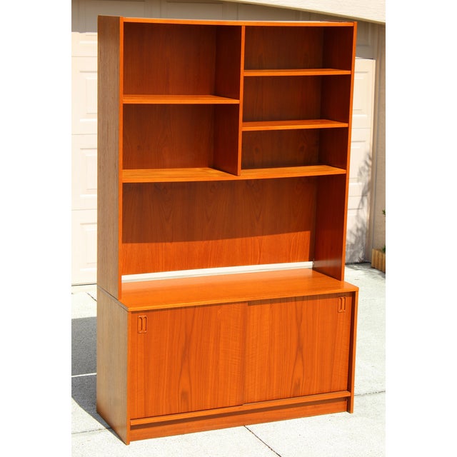 Bring mid-century Scandinavian style into your home with this 1970s Danish Modern teak bookcase. Featuring a stackable...