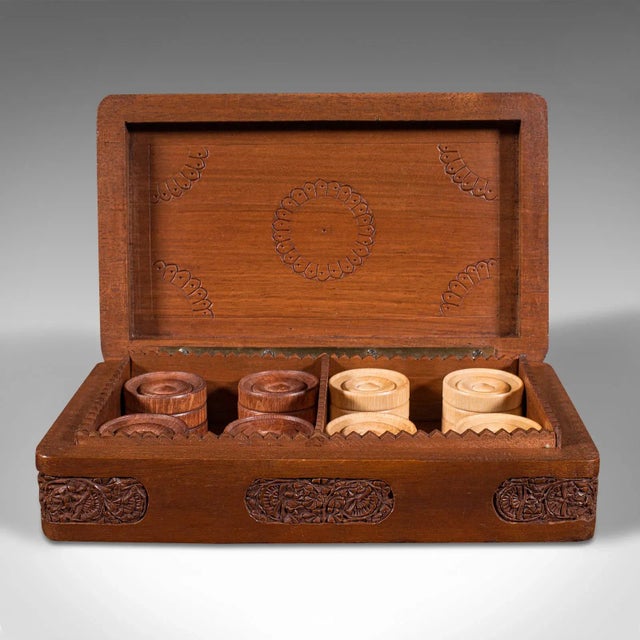 This is a set of vintage gentleman's club draughts pieces. An Oriental, mahogany game counter and carry case, dating to...