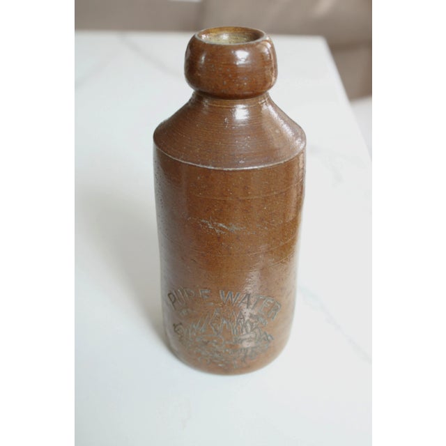 A antique stoneware bottle with advertising Pure Water CO LtD. We think these unique stoneware bottles are great for...