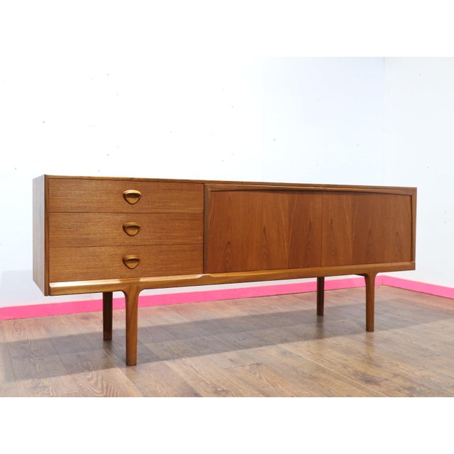 Elevate your home with the exquisite Mid Century Modern Vintage Teak Credenza sideboard by renowned furniture maker...