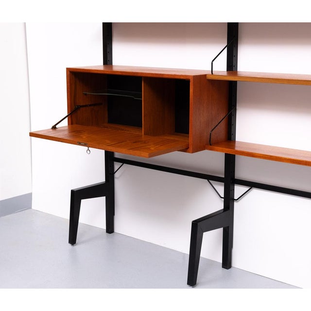 Stunning Poul Cadovius free standing wall system . No drilling in the wall Beautiful warm Teak color .Black Metal frame ....