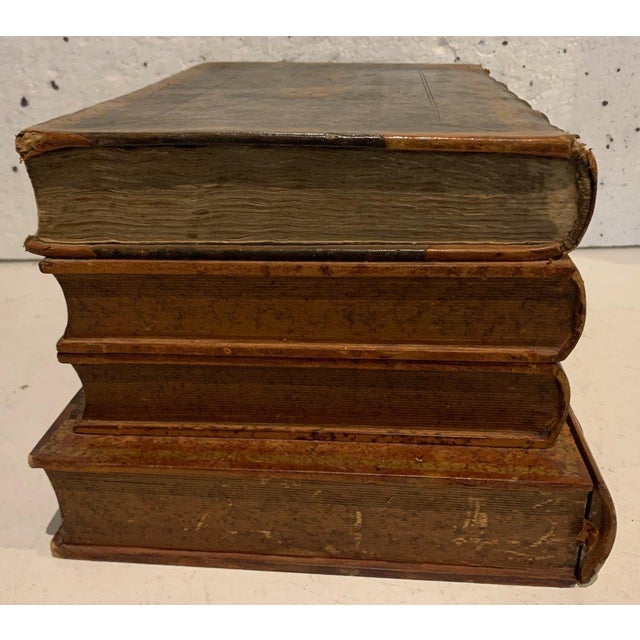 A set of four trompe l'oeil books the first part forms a liqueur cellar with 14 glasses the glassware is from baccarat the...