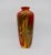 A tall and colorful English Royal Doulton Flambe vase signed by Frederick Moore, circa 1920s-early 1930s. The large art...