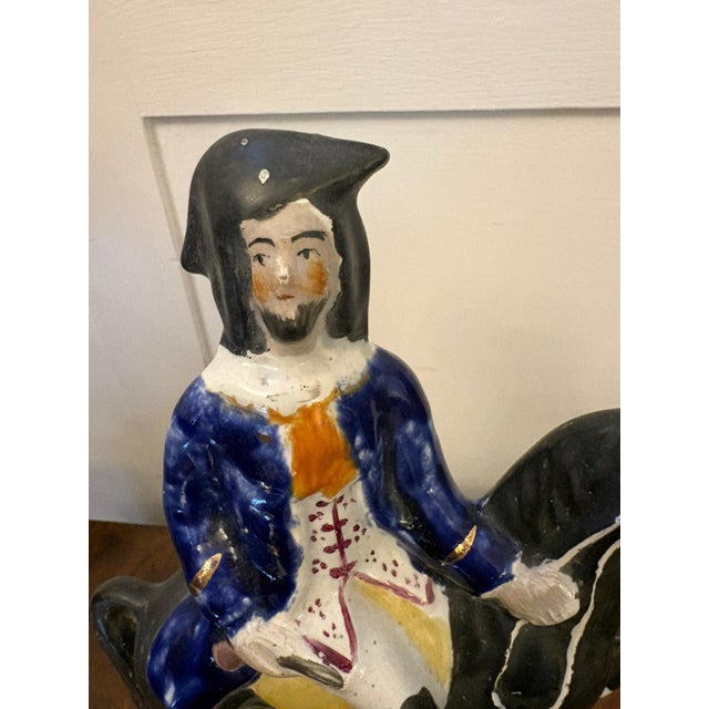A charming antique Staffordshire pottery figure depicting the infamous English highwayman Dick Turpin mounted on...