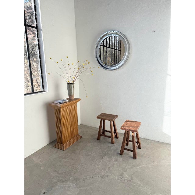 Set of two 1960s solid oak stools. Their rectangular seats rest on flared legs with a wide base and a cross brace,...