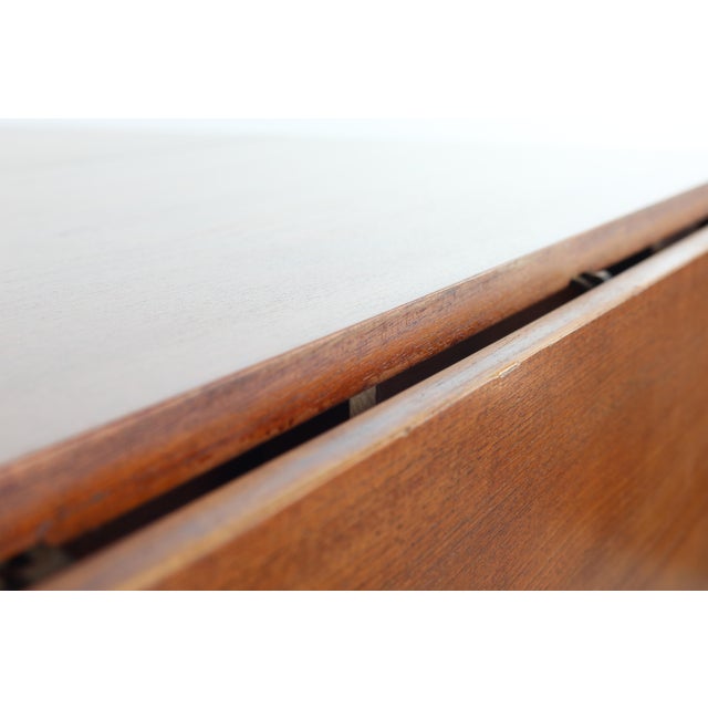 An exceptional Minimalist midcentury Danish Modern teak extension dining table. Very versatile, with drop leaves and two...