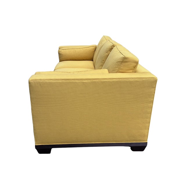 Elegant Baker Furniture tuxedo sofa featuring clean architectural lines, deep plush seating, and luxurious golden corduroy...