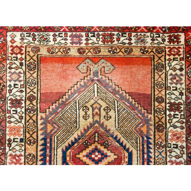 A fantastic mid-20th century Persian Serab rug with two large central diamond medallions each with a stylized central...