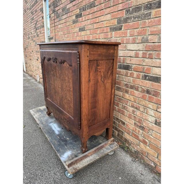 An antique French confiturier cabinet, likely dating to the Late 18th century, features traditional country styling...