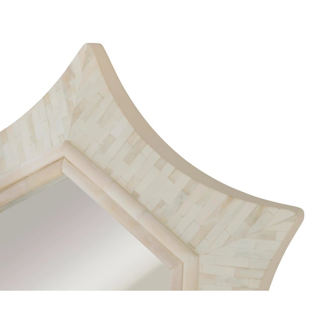 Elegant inlaid bone mirror in a curved star pattern.